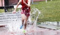 Steeplechase runner splashing in water Royalty Free Stock Photo