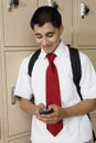 High School Boy Text Messaging By School Lockers Royalty Free Stock Photo