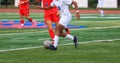 Soccer player dribbling the ball past a defender during a game Royalty Free Stock Photo