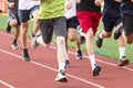 High school boys running in a group on a red track Royalty Free Stock Photo