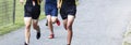 Boys running 5K race on gravel path at park Royalty Free Stock Photo