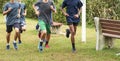 Group of teenage boys running in a park Royalty Free Stock Photo