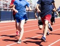 High school boys traiining together on a red track Royalty Free Stock Photo