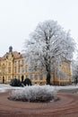 High school building amongst hoar frosted trees in cold winter day