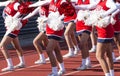 High school cheerleadeers cheering during a football game