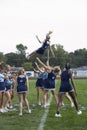 High school cheerleaders perform at a football game