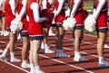 High school cheerleaders standing on the track during a football game