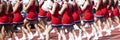 High school cheerleaders cheering during a football game