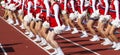 High school cheerleaders perfomring on a track during football game Royalty Free Stock Photo