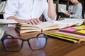 High school or college student group sitting at desk in library