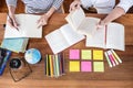 High school or college student group sitting at desk in library studying and reading, doing homework and lesson practice preparing Royalty Free Stock Photo