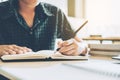 High school or college student studying and reading in library Royalty Free Stock Photo