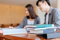 High school or college students  group catching up workbook and learning tutoring on desk and reading, doing homework, lesson Royalty Free Stock Photo