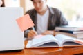 High school or college students  group catching up workbook and learning tutoring on desk and reading, doing homework, lesson Royalty Free Stock Photo