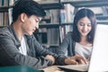 High school or college students studying and reading together in library. Student use laptop at library Royalty Free Stock Photo