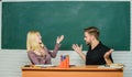 High school education. Couple studying in classroom. Man and woman back to school. Pretty teacher and handsome Royalty Free Stock Photo