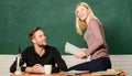 High school education. Pretty teacher and handsome schoolmaster grading papers. University or college students. Couple Royalty Free Stock Photo