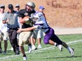 High School Football Player Being Tackled During a Game