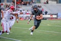 High school football player running with ball