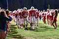 High School Football Players Leaving the field