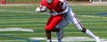 Football receiver trying to escape a tackle after catching the ball during a game