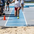 Front view of young women triple jumping during competition Royalty Free Stock Photo