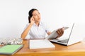 high school girl at desk reading and thinking using laptop Royalty Free Stock Photo