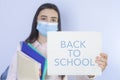 High school girl with mask on her showing back to school message Royalty Free Stock Photo