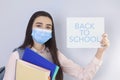 High school girl with mask on her showing back to school message Royalty Free Stock Photo