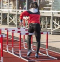 Female hurdle runner wearing headphones