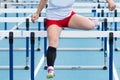 High school girl racing in the hurdles