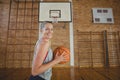 High school girl standing with basketball in the court Royalty Free Stock Photo