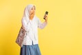 high school girl in veil shocked looking at smartphone screen Royalty Free Stock Photo