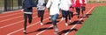 High school girls run training on a track together Royalty Free Stock Photo