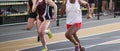 High school girls running to the finish line during an indoor track and field race Royalty Free Stock Photo