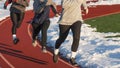Three girls running on a track at practice in the snow Royalty Free Stock Photo