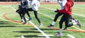 High school girls track team doing sprint form drills on a turf field in winter Royalty Free Stock Photo