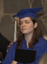 High school Graduate prays at the high school graduation