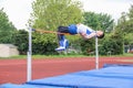 HIgh school high jumper clears bar Royalty Free Stock Photo