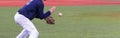 Baseball infielder fielding a baseball