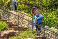 High school kids goofing around in park - boy climbing stairs with long haired girl riding piggy back - selective focus and motion