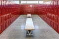 A high school locker room with metal lockers, and wood benches. Royalty Free Stock Photo