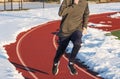 High school runner on track with snow Royalty Free Stock Photo