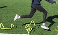 Runner tripping over mini hurdles on turf field Royalty Free Stock Photo