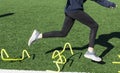 Runner tripping over mini hurdles on turf field