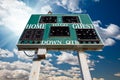 High School Scoreboard Over Blue Sky with Clouds Royalty Free Stock Photo