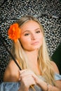 High school senior poses with umbrella for portraits on a rainy