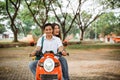 High school student couple smiling while riding motorbike Royalty Free Stock Photo