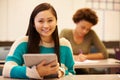 High School Student At Desk In Class Using Digital Tablet Royalty Free Stock Photo