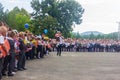 High school student with a first grader in her arms and other schoolchildren in the schoolyard at the grand opening of the school